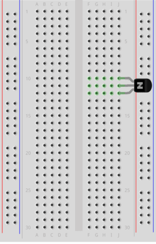 Breadboard with transistor, resistor, LED, and touchpad.